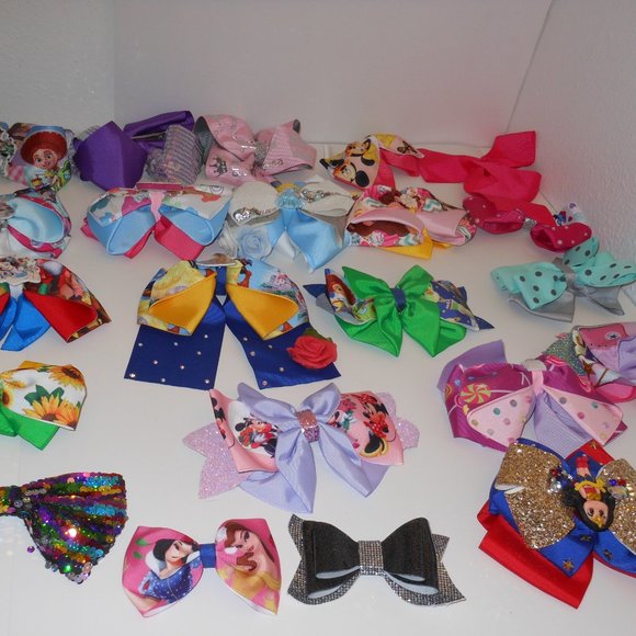 A COLLECTION OF DISNEY HAIR BOW TIE CLIPS VARIOUS STYLES AND DESIGNS